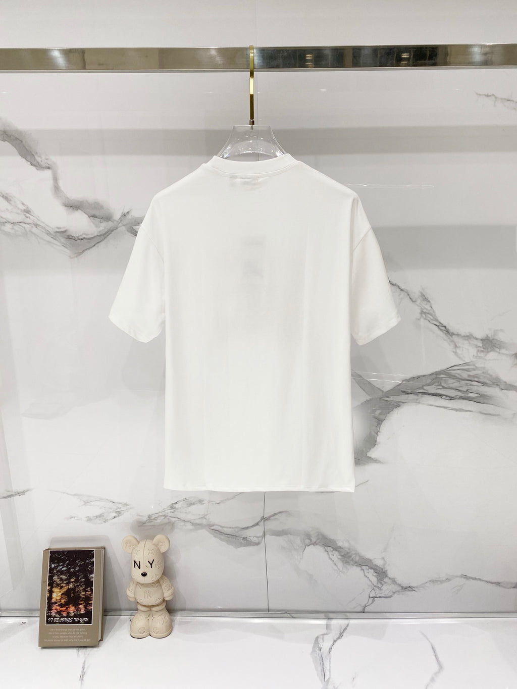 White Burberry short-sleeve T-shirt on a hanger, plain back view