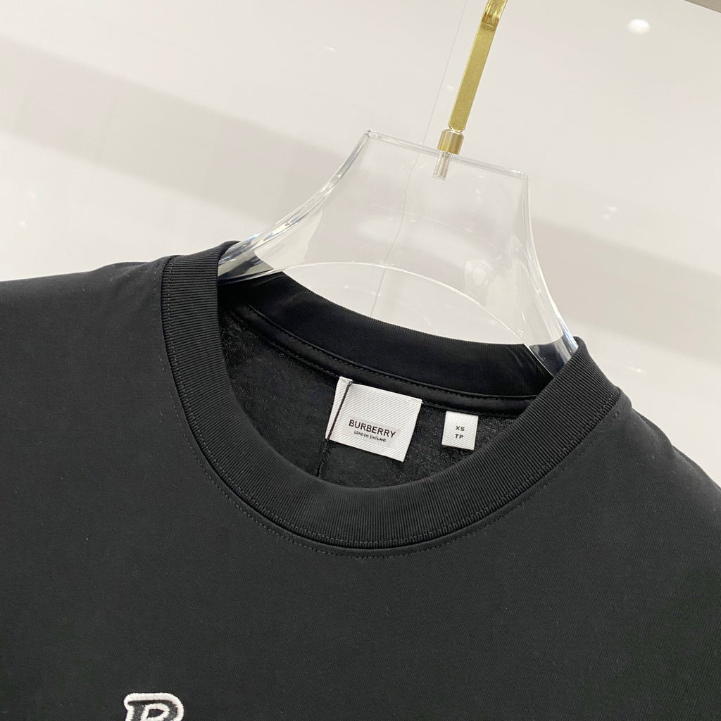 Black crewneck T-shirt neckline with small interior neck label