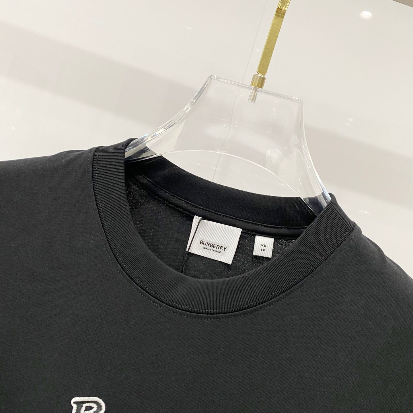 Black crewneck T-shirt neckline with small interior neck label