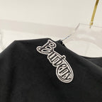 Black T-shirt with large embroidered logo on the sleeve