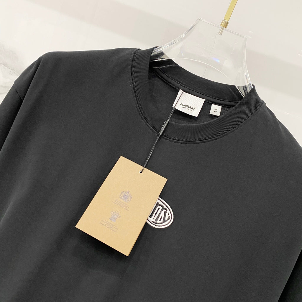 Black crewneck T-shirt with attached tag at the collar