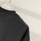 Black crewneck T-shirt sleeve hem detail