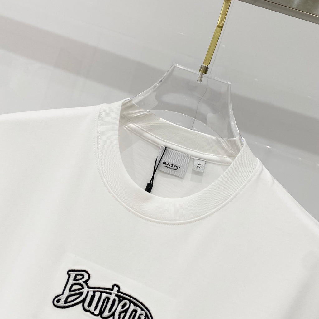 White short-sleeve T-shirt neckline with black “Butter” graphic logo patch