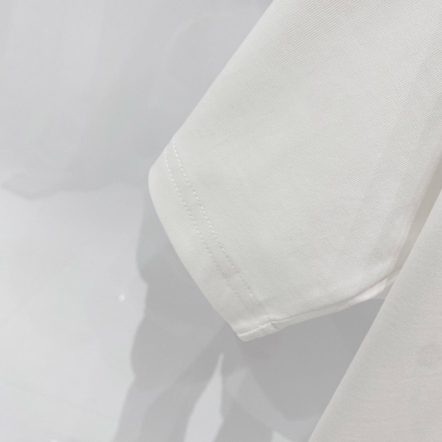 White short-sleeve T-shirt fabric texture and side seam/hem detail