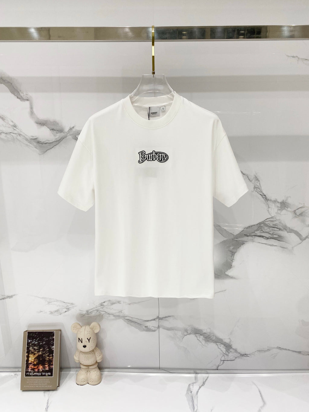 Burberry white short-sleeve T-shirt with black “Butter” graphic logo on chest