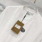 White short-sleeve T-shirt with “Butter” logo and hanging size/brand tag
