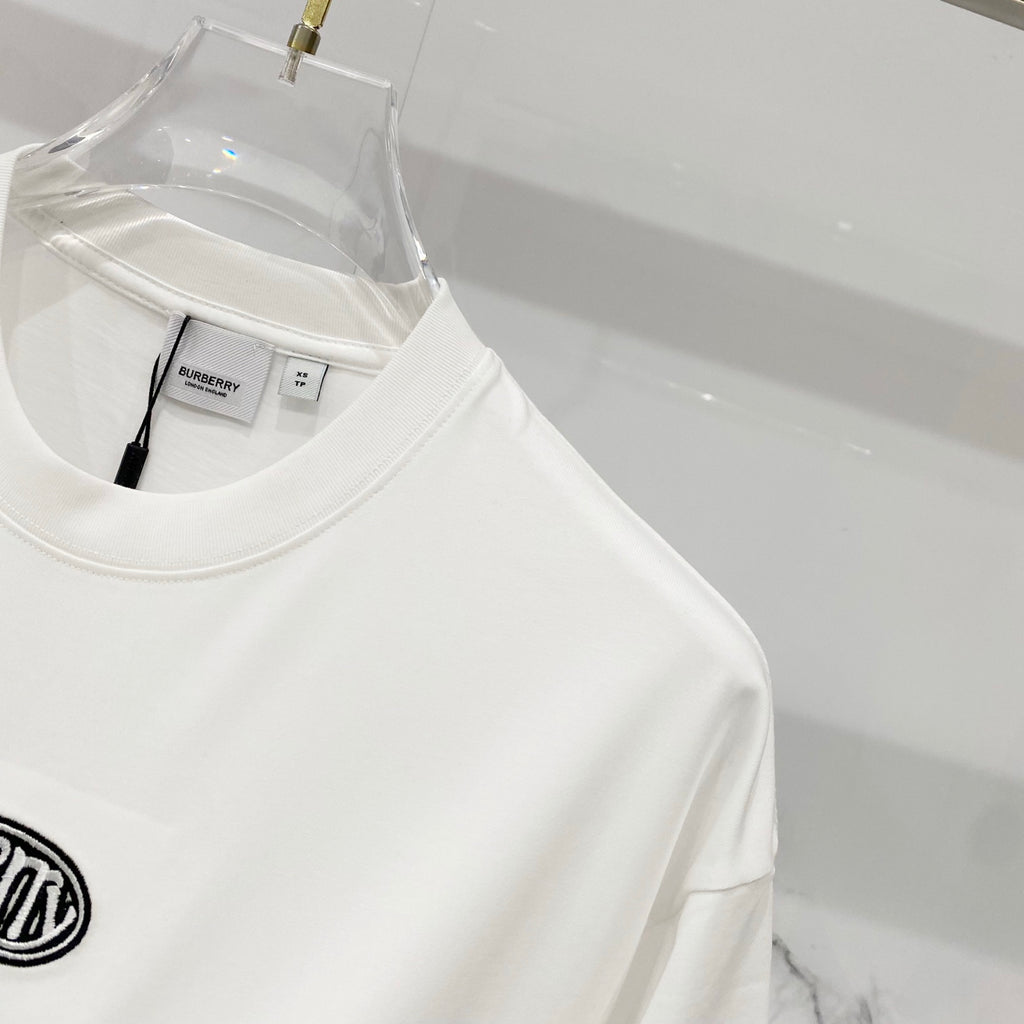 White short-sleeve T-shirt on hanger with interior neck label visible
