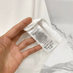White short-sleeve T-shirt care label with Burberry text