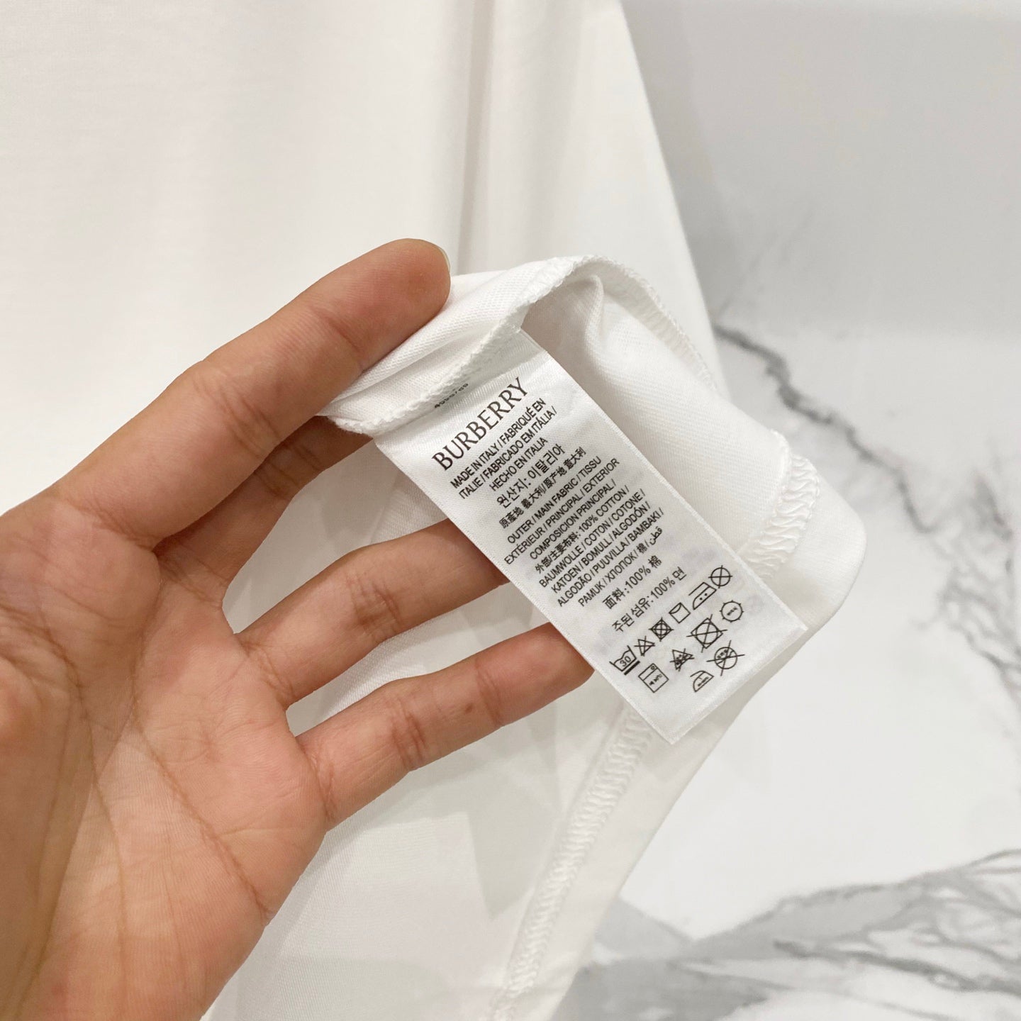 White short-sleeve T-shirt care label with Burberry text