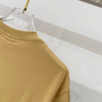 Tan T-shirt sleeve hem with stitched cuff detail