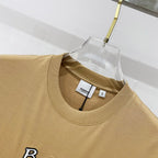 Tan crewneck T-shirt neckline with interior brand label and size tag