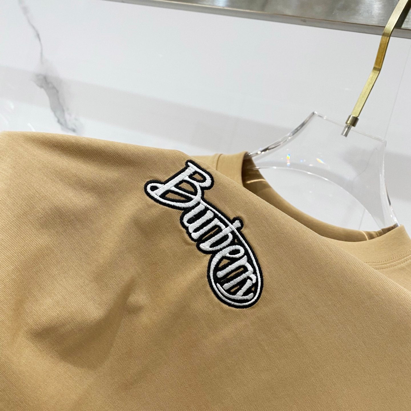 Tan T-shirt with large embroidered Burberry logo graphic