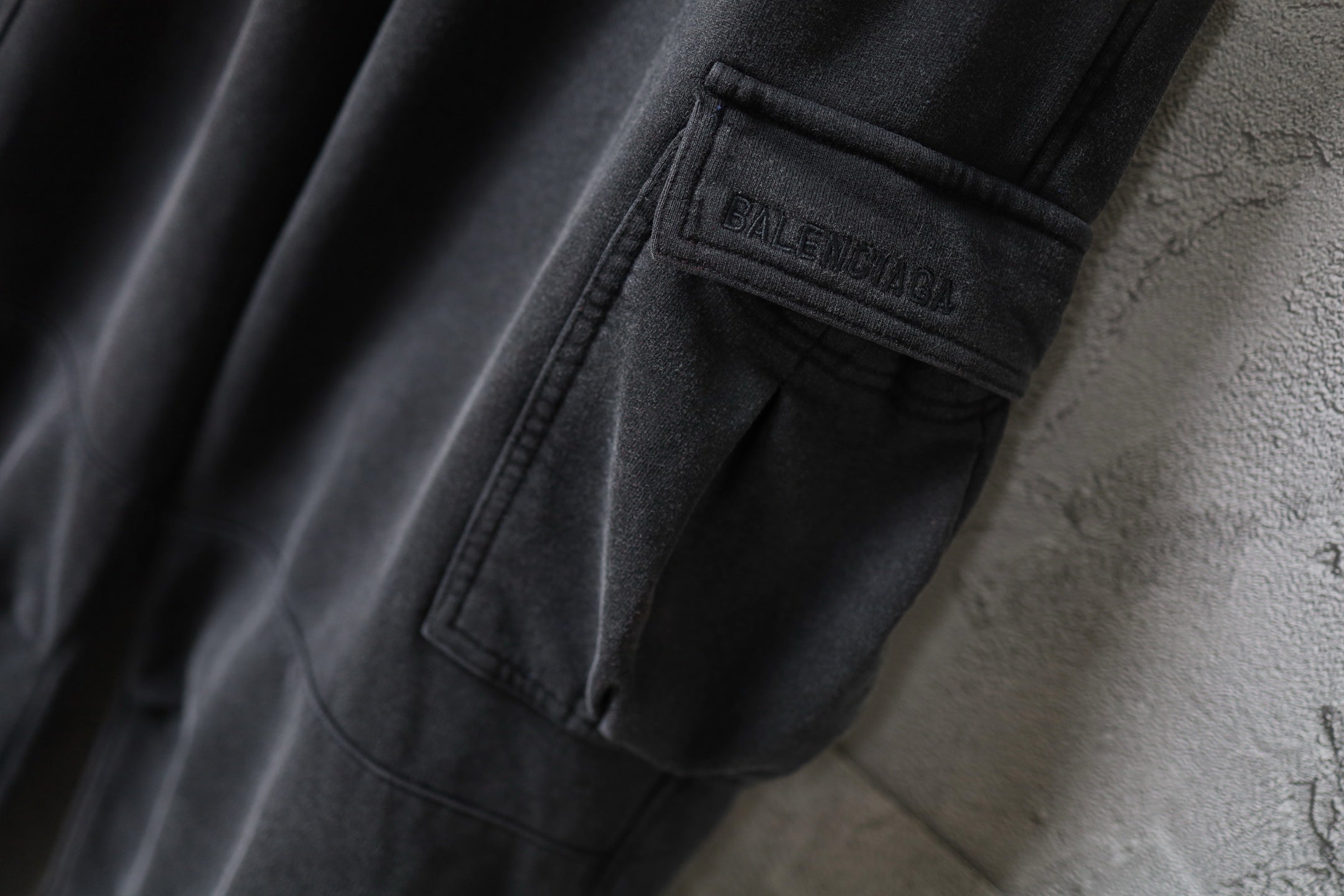 Dark gray cargo pants with Balenciaga label on pocket