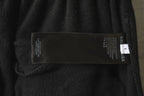 Balenciaga pants label on dark gray fabric