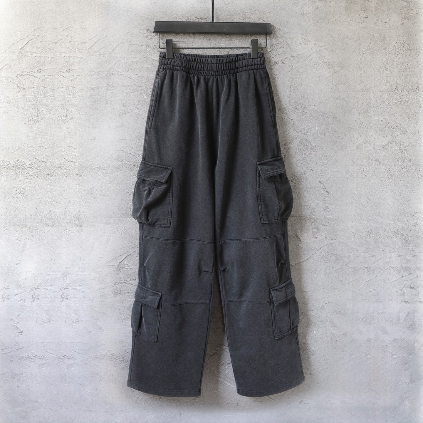 Dark gray cargo pants with elastic waistband and side cargo pockets