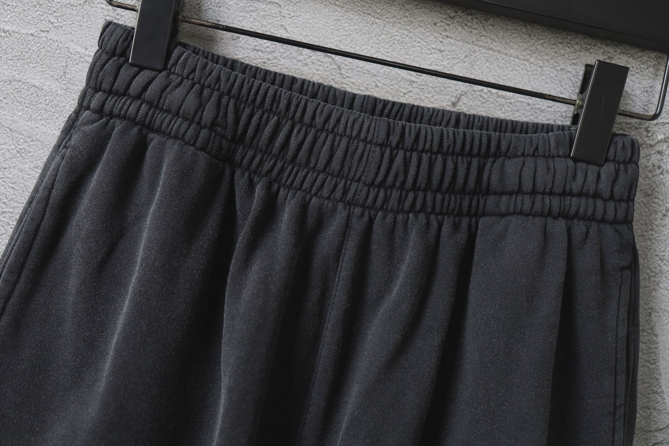 Dark gray cargo pants waistband with elastic gathers
