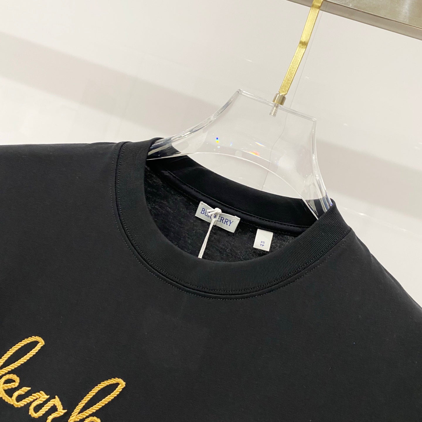 Black crewneck T-shirt neckline with Burberry label on inner collar