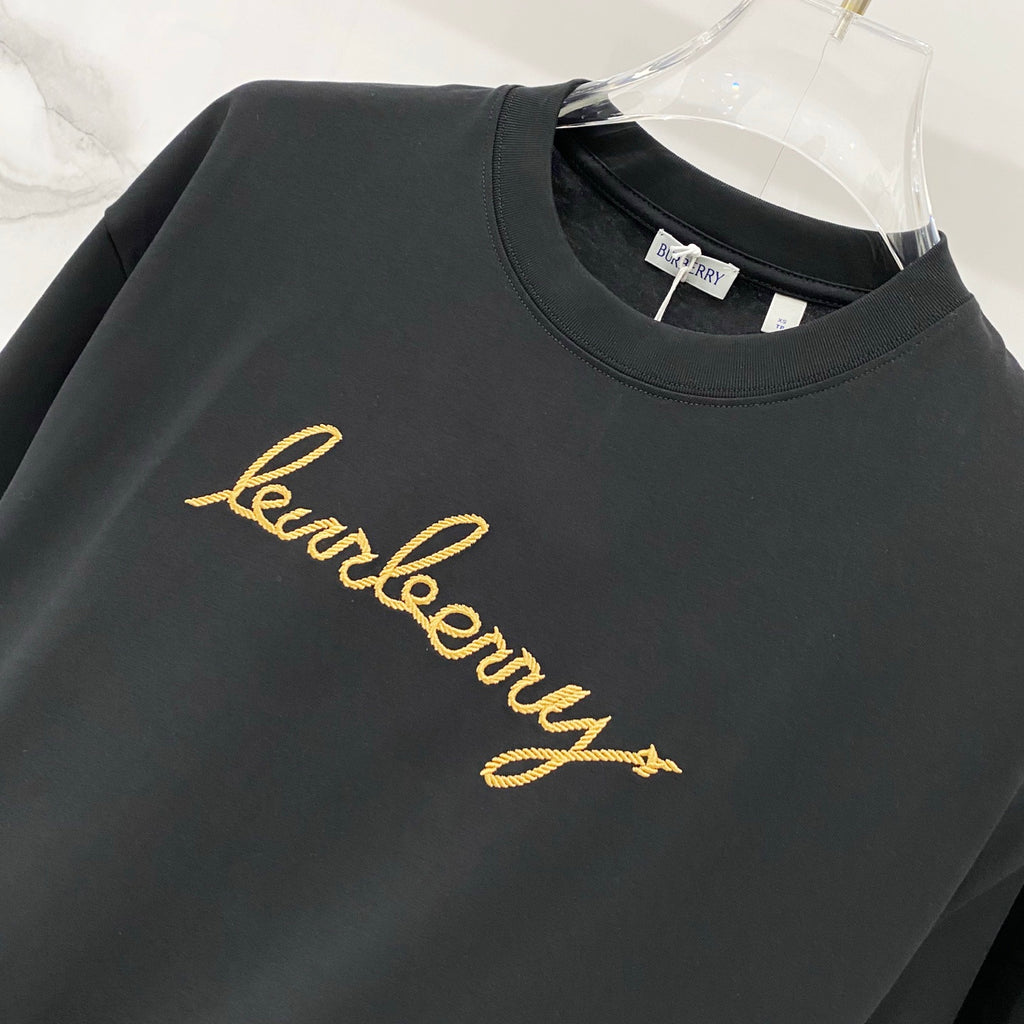 Black crewneck T-shirt with gold Burberry script logo across chest