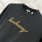 Black crewneck T-shirt with gold Burberry script logo across chest