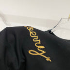 Black T-shirt back with vertical gold Burberry script logo