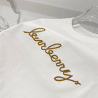 White short-sleeve T-shirt with gold embroidered logo text across the chest