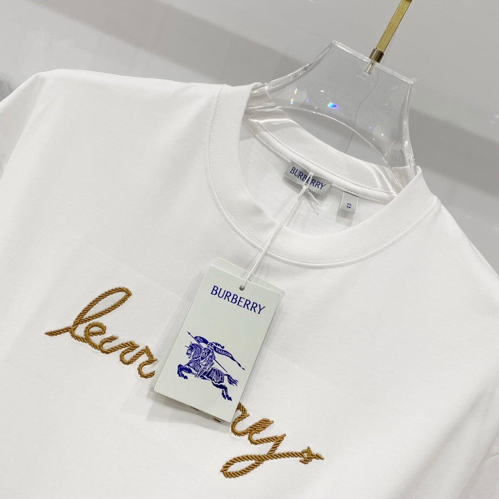 White short-sleeve T-shirt with blue horse logo and gold logo text