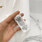 White T-shirt with neck care label visible inside neckline