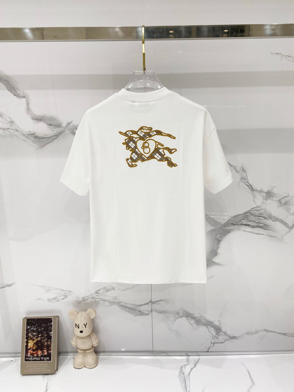 White short-sleeve T-shirt with gold horse rider graphic on the back
