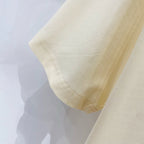 Burberry short-sleeve T-shirt sleeve cuff in pale cream with visible stitching