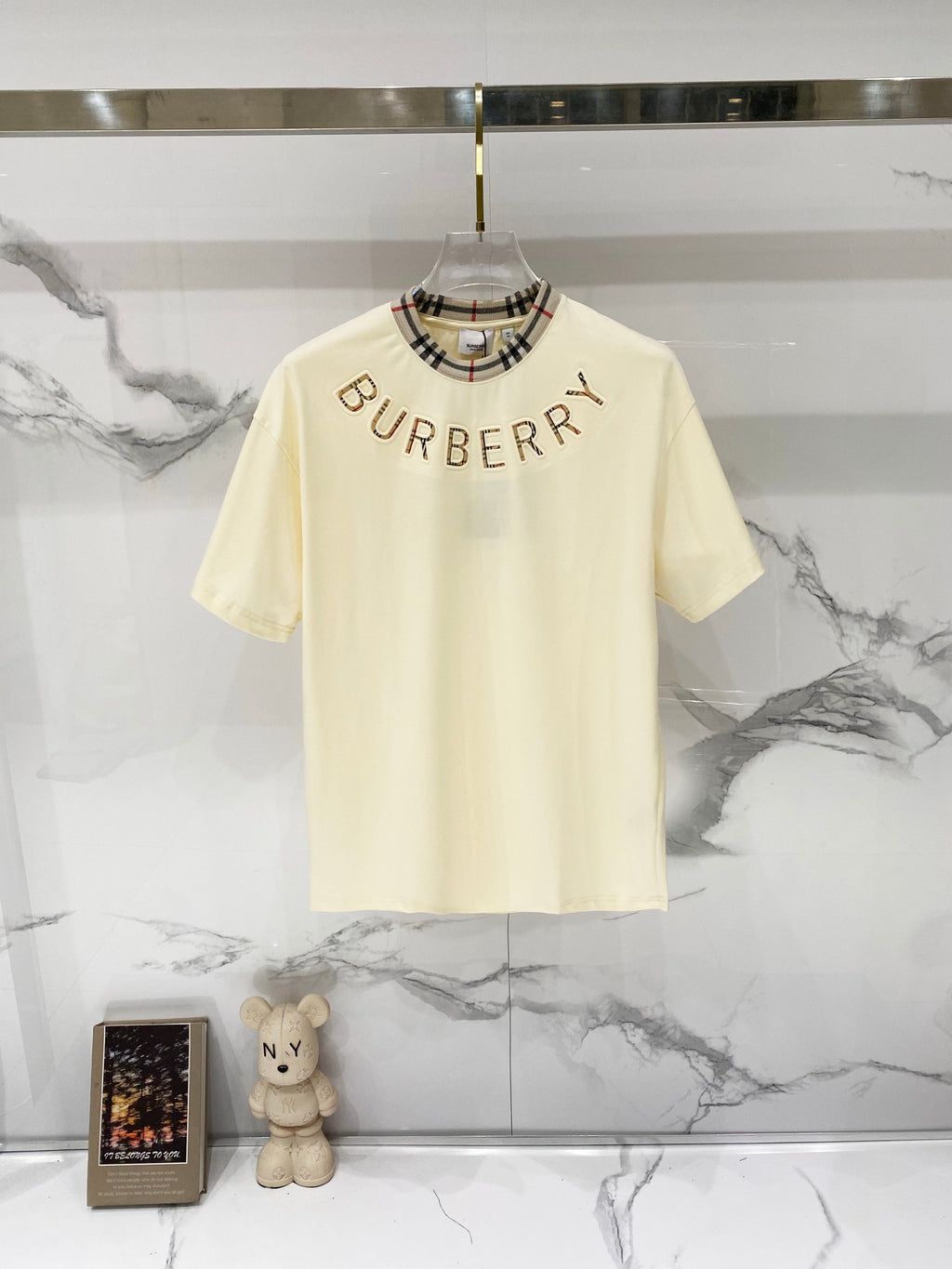 Burberry short-sleeve T-shirt in pale cream with plaid-trim crew neck and BURBERRY print