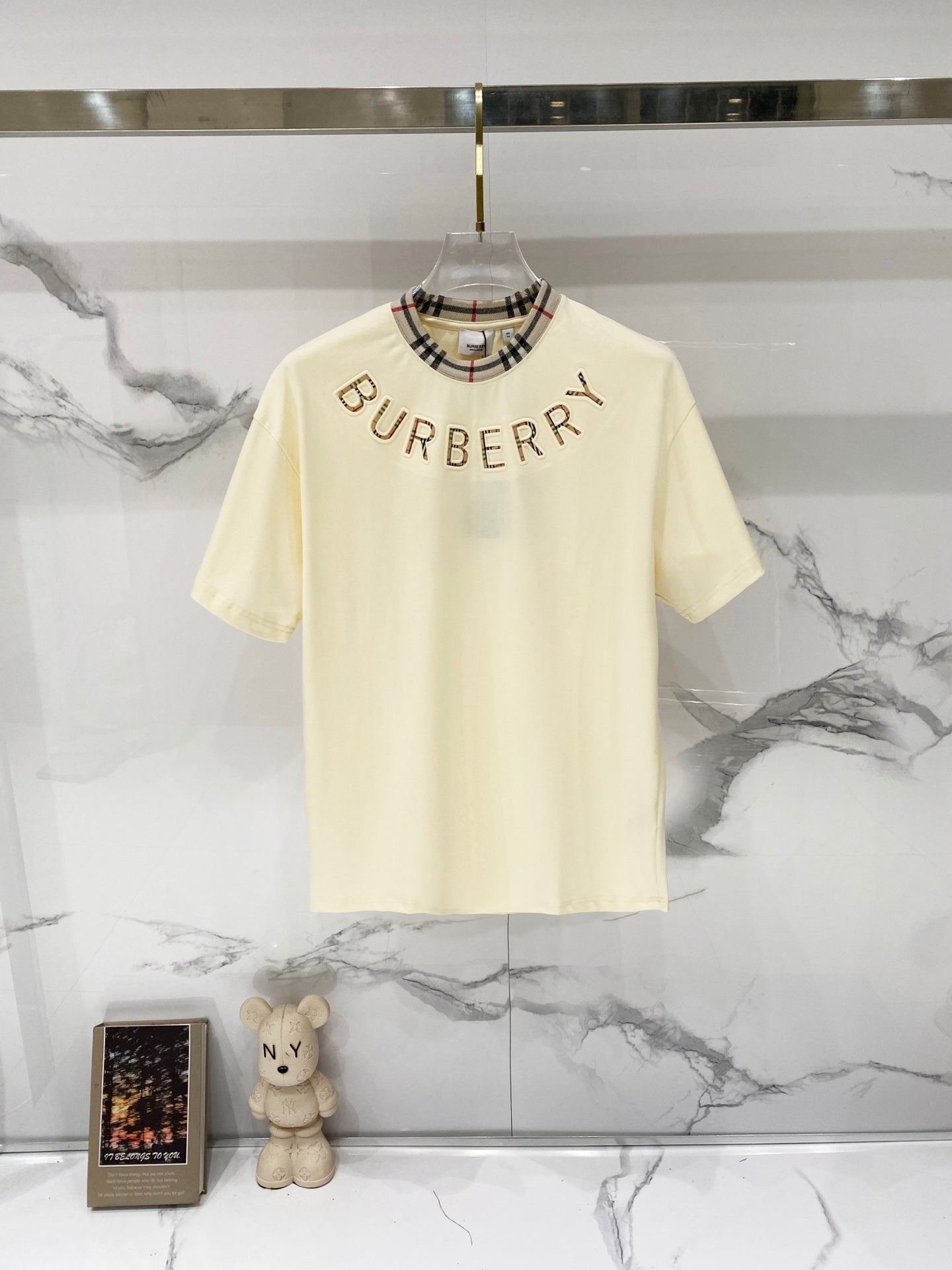 Burberry short-sleeve T-shirt in pale cream with plaid-trim crew neck and BURBERRY print