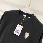 Black short-sleeve T-shirt with chest heart emblem and hanging tag