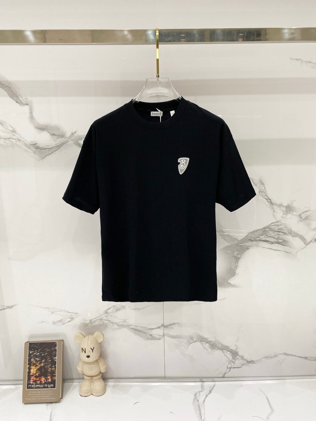 Black short-sleeve T-shirt with small chest crest logo