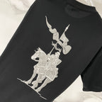 Black T-shirt with large white cartoon-style graphic