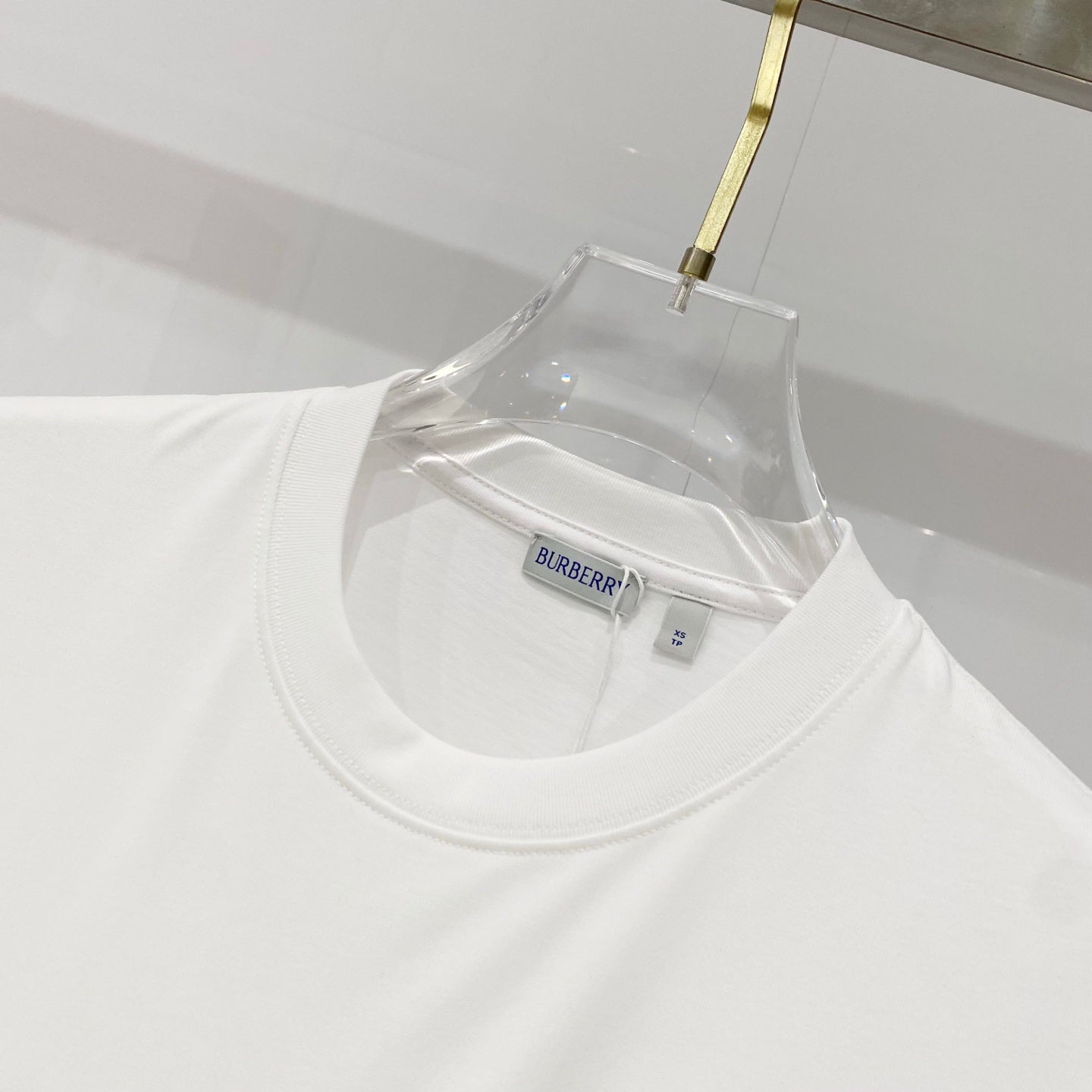 White Burberry T-shirt neckline with inner brand and size label.