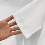 White Burberry T-shirt sleeve cuff with stitched hem.