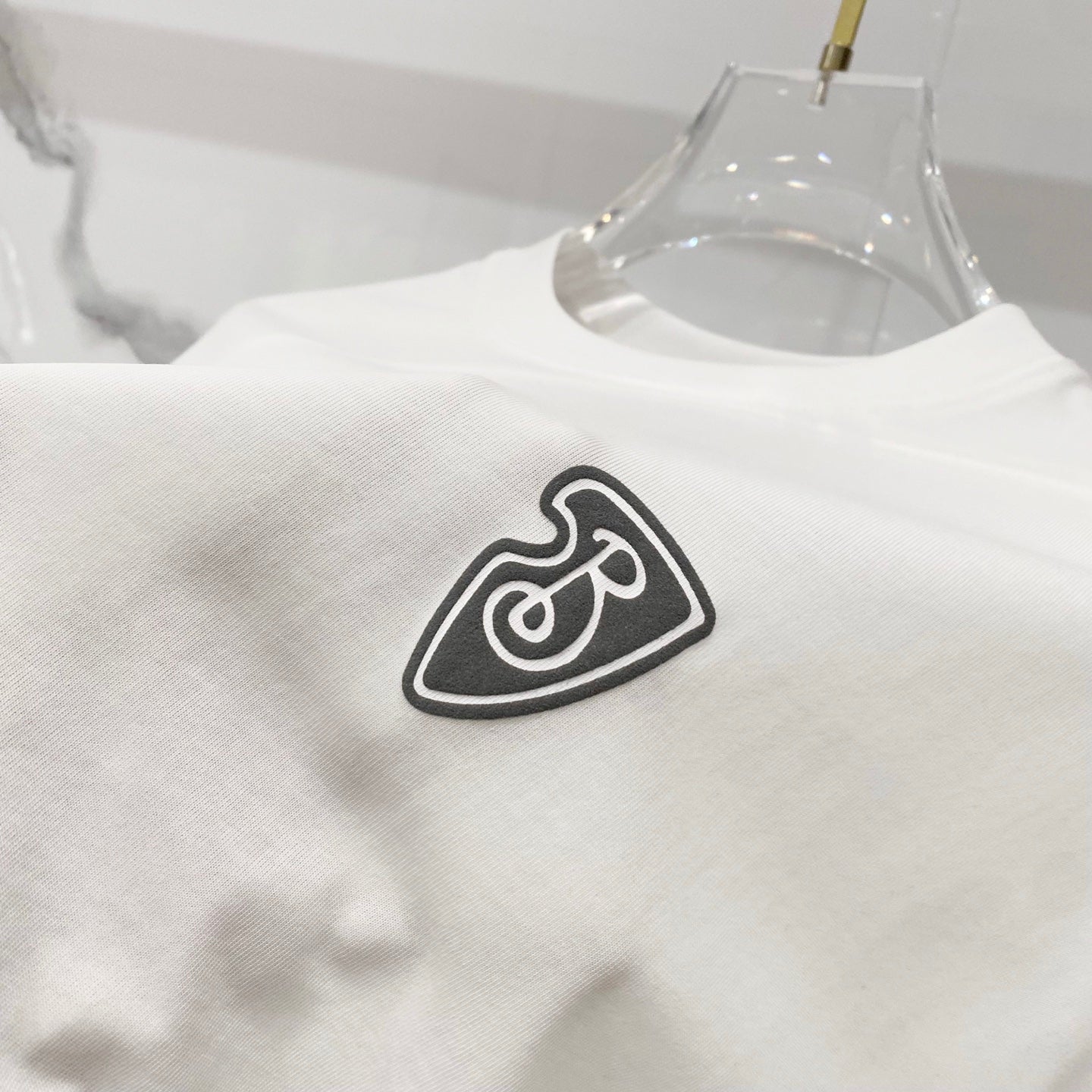 White Burberry T-shirt with black heart B logo print on front.