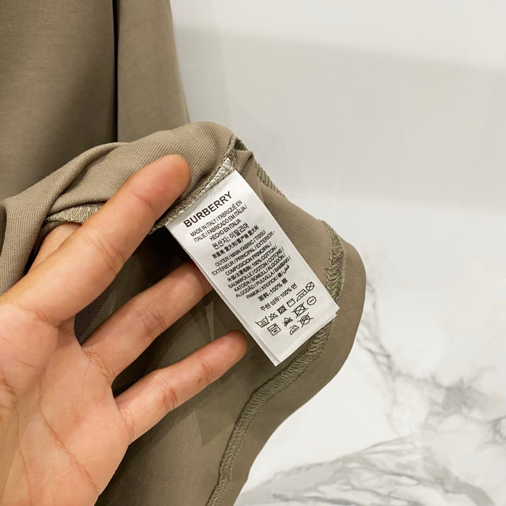 Burberry olive T-shirt care label near neckline on inner neck tag