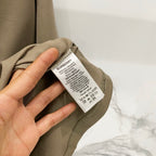 Burberry olive T-shirt care label near neckline on inner neck tag