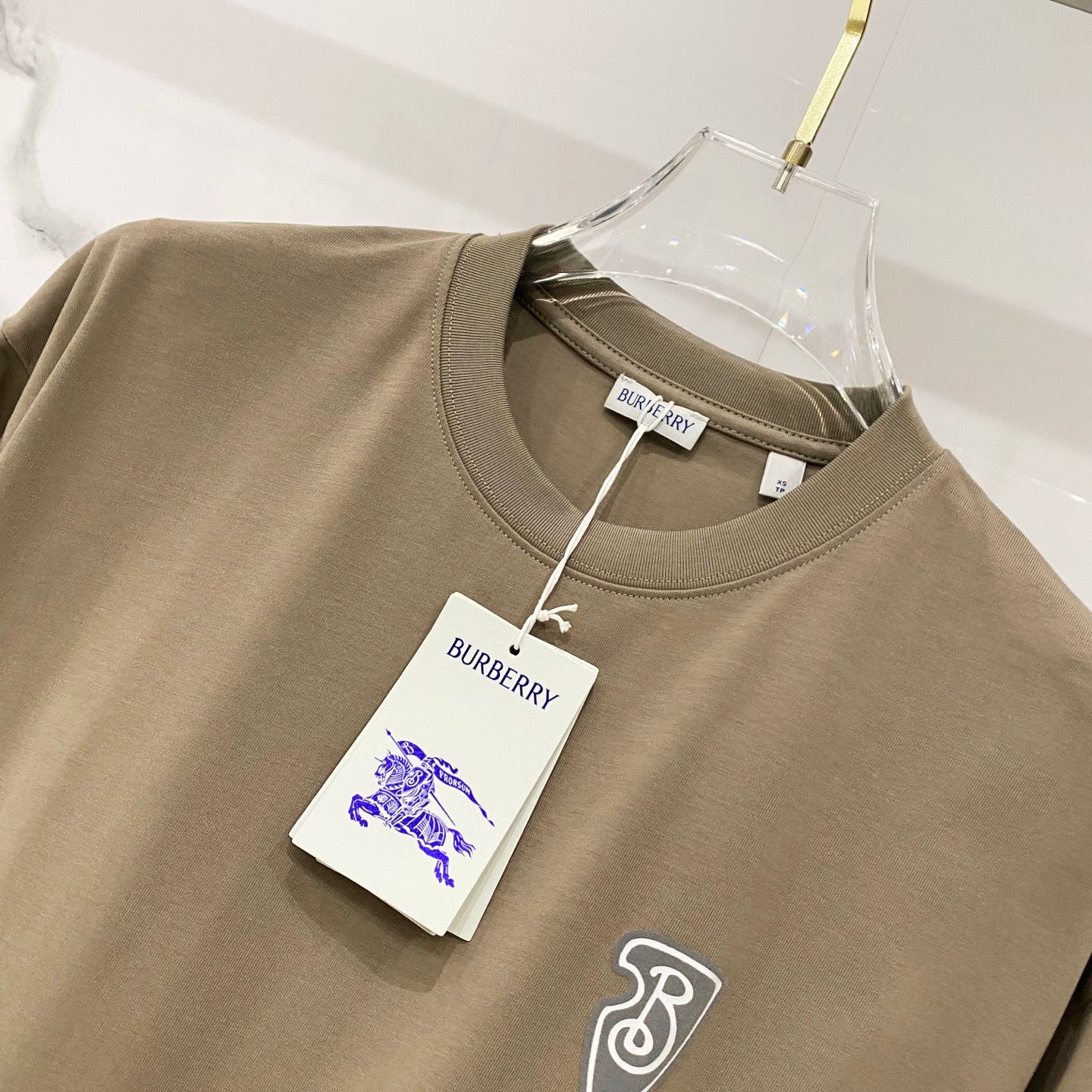 Burberry olive T-shirt close-up with neck tag and small front logo