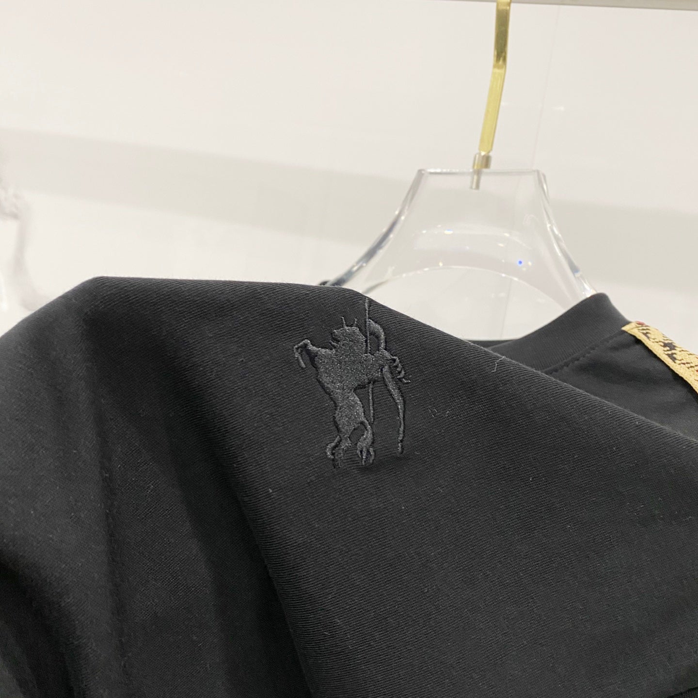 Black Burberry T-shirt back close-up with embroidered polo player logo.