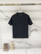 Black Burberry crew-neck T-shirt on hanger, short sleeves, simple design.