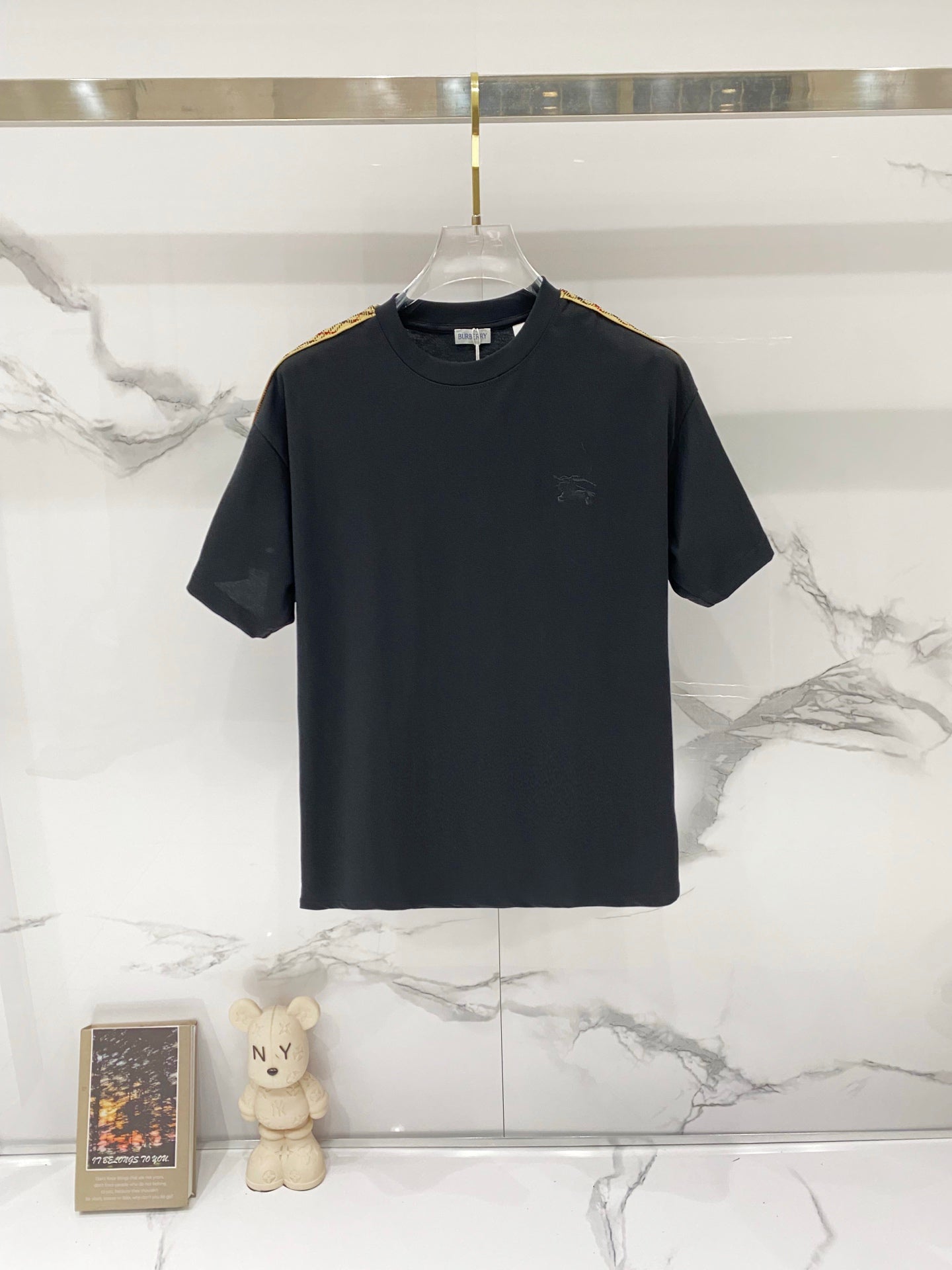 Black Burberry short-sleeve T-shirt on hanger, crew neck, plain front.