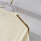 Cream T-shirt with patterned trim along shoulder and sleeve edge