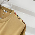 Mustard short-sleeve T-shirt shoulder with multicolor plaid trim along sleeve edge