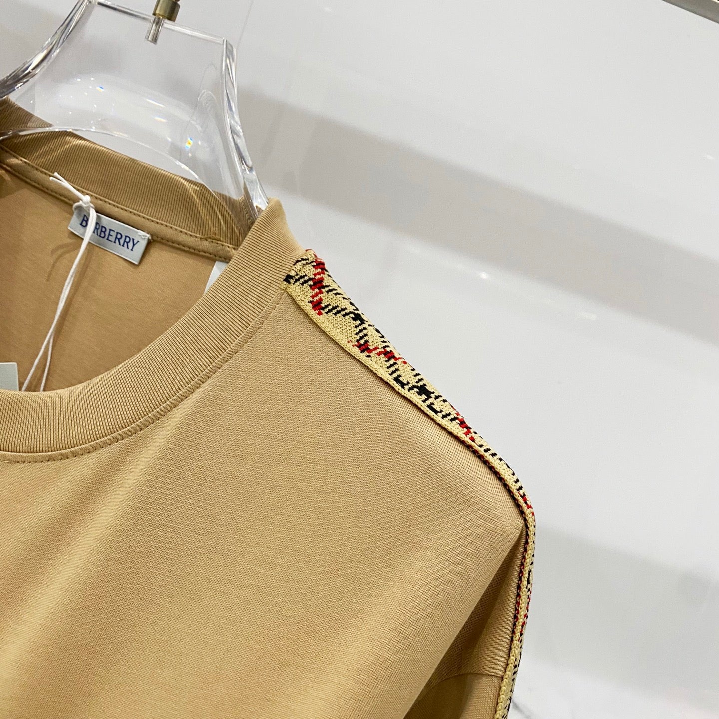 Mustard short-sleeve T-shirt shoulder with multicolor plaid trim along sleeve edge