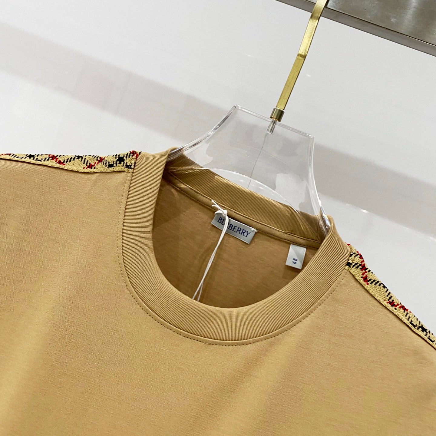 Mustard crewneck T-shirt neckline close-up with inner Burberry hang tag
