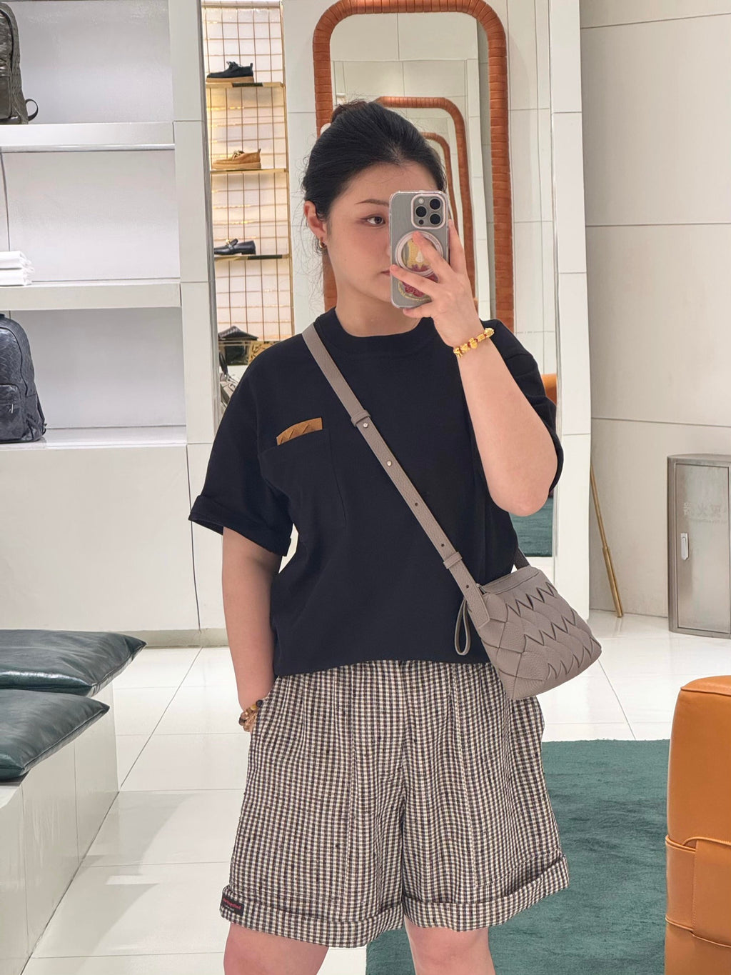 Dark short-sleeve top with chest pocket and checkered off-white shorts