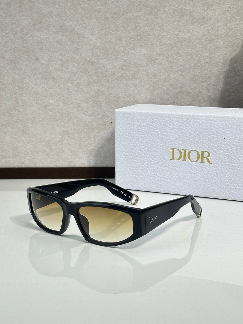 Dior sunglasses with black frame and amber-tinted lenses