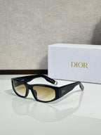 Dior sunglasses with black frame and amber-tinted lenses